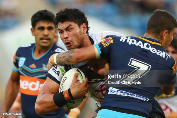 Jordan McLean of the Cowboys is tackled by Jarrod Wallace of the Titans during the round 12 NRL match between the Gold Coast Titans and the North...