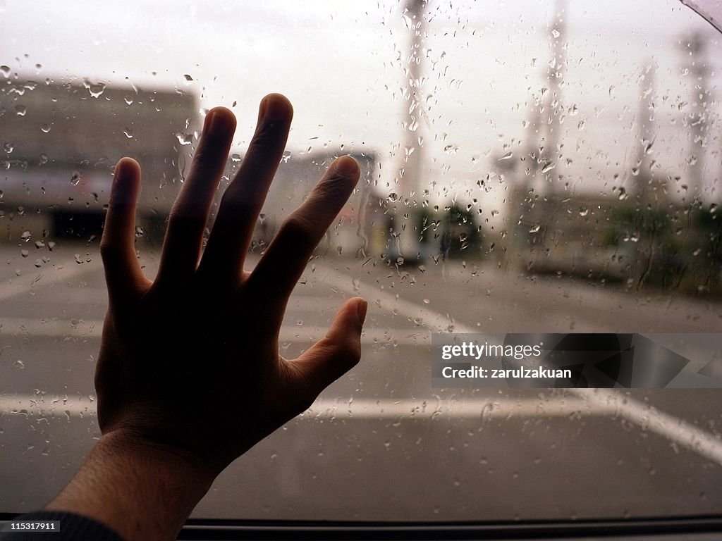 Hand against window