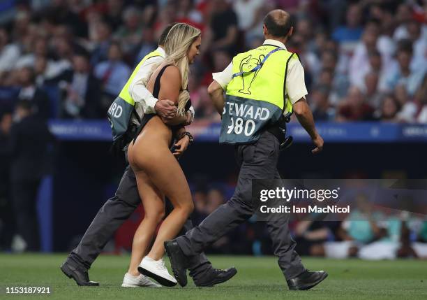 Kinsey Wolanski is led from the pitch during the UEFA Champions League Final between Tottenham Hotspur and Liverpool at Estadio Wanda Metropolitano...