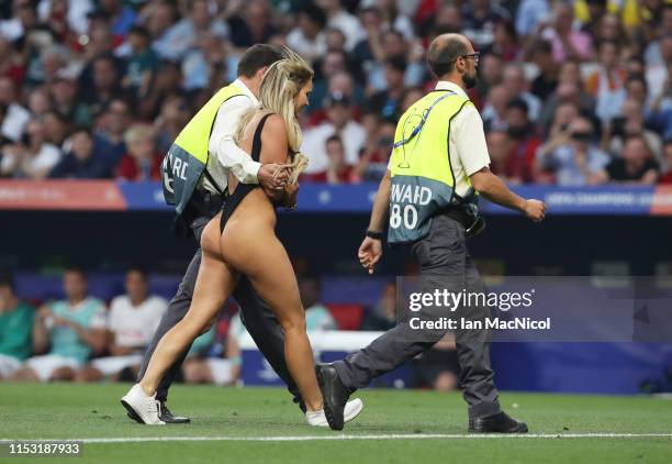 Kinsey Wolanski is led from the pitch during the UEFA Champions League Final between Tottenham Hotspur and Liverpool at Estadio Wanda Metropolitano...