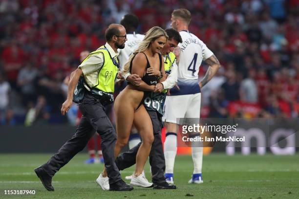 Kinsey Wolanski is led from the pitch during the UEFA Champions League Final between Tottenham Hotspur and Liverpool at Estadio Wanda Metropolitano...