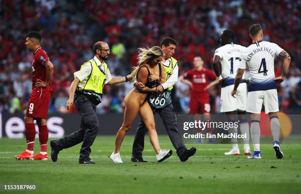 Kinsey Wolanski is led from the pitch during the UEFA Champions League Final between Tottenham Hotspur and Liverpool at Estadio Wanda Metropolitano...