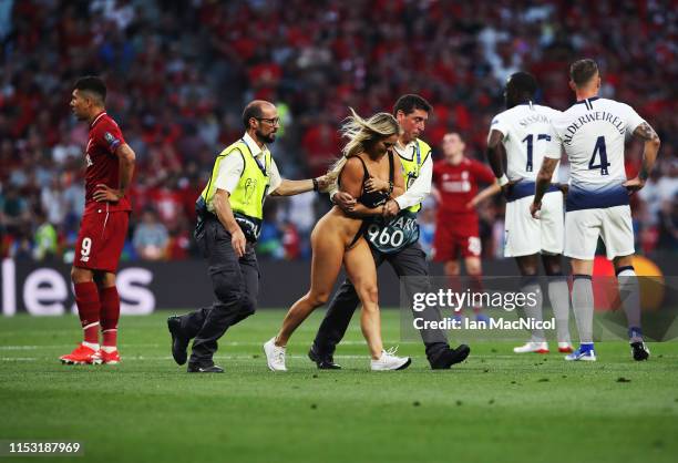 Kinsey Wolanski is led from the pitch during the UEFA Champions League Final between Tottenham Hotspur and Liverpool at Estadio Wanda Metropolitano...