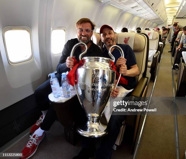 Jurgen Klopp manager of Liverpool with part owner Mike Gordon with the UEFA Champions League trophy during the flight home from winning the UEFA...