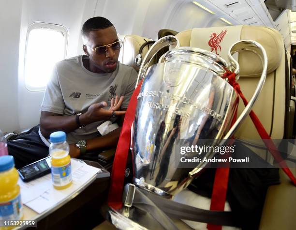 Daniel Sturridge of Liverpool with the UEFA Champions League trophy during the flight home from winning the UEFA Champions League on June 02, 2019 in...