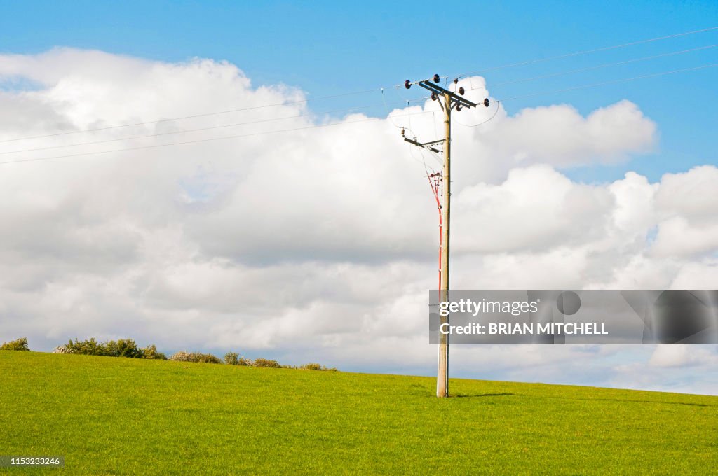 Electricity high voltage cable pole in a rural setting