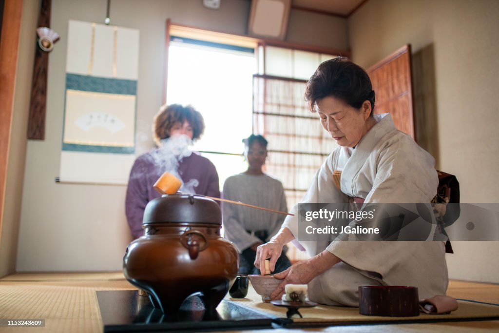 Japanese tea master whisking matcha tea