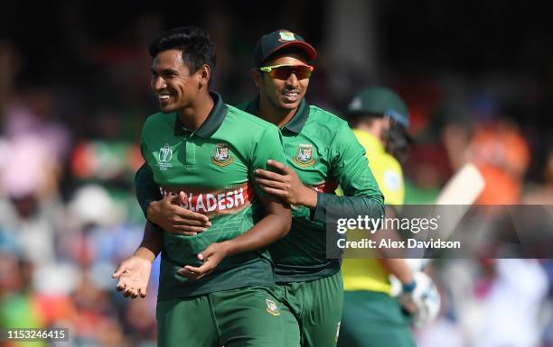 Mustafizur Rahman of Bangladesh celebrates the wicket of David Miller of South Africa with Soumya Sarkar of Bangladesh during the Group Stage match...