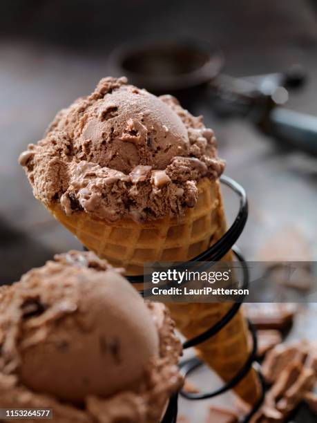 double chocolate chunk ice cream in a waffle cone - chocolate ice cream cone stock pictures, royalty-free photos & images