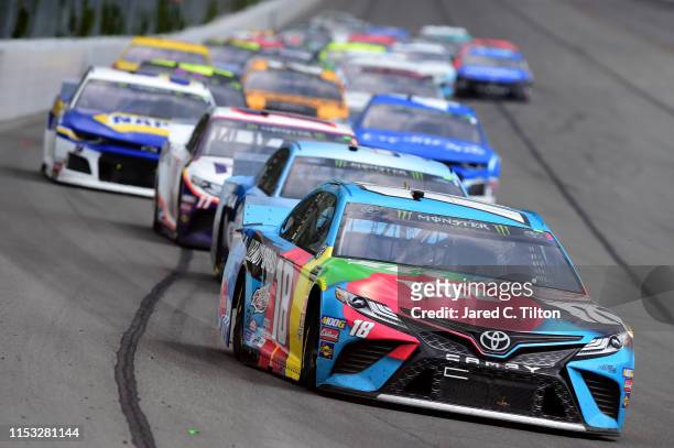Kyle Busch, driver of the M&M's Hazelnut Toyota, leads a pack of cars during the Monster Energy NASCAR Cup Series Pocono 400 at Pocono Raceway on...