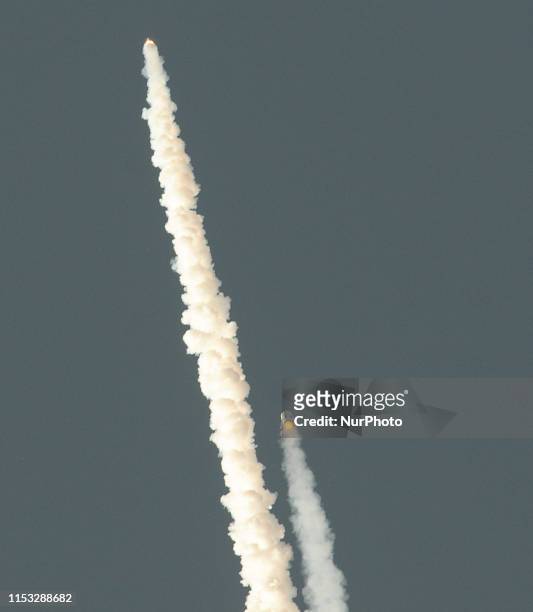 Orion test vehicle ascends after launching and separating from its booster rocket from Space Launch Complex 46 at Cape Canaveral Air Force Station in...