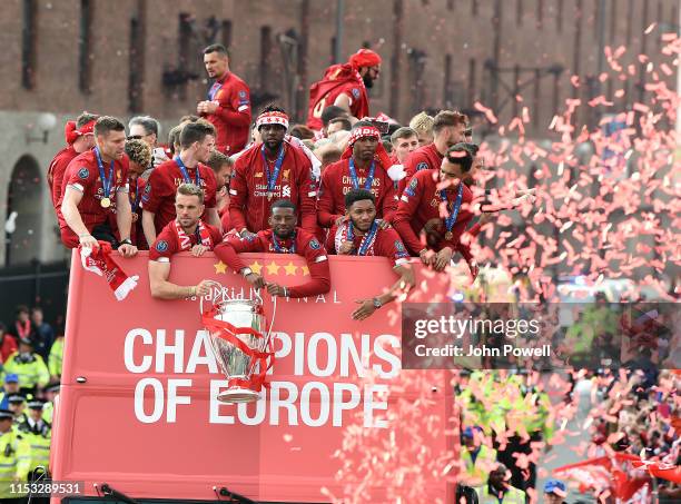 Liverpool's players celebrate with the European Champion Clubs' Cup on board an open-top bus during the UEFA Champions League victory parade, after...