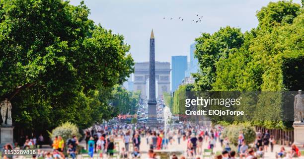 view of obelisque de louxor, place de la concorde and arc de triomphe from jardin des tuileries, paris, france - la concorde stock pictures, royalty-free photos & images