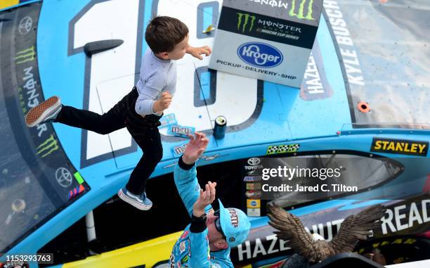 Kyle Busch, driver of the M&M's Hazelnut Toyota, celebrates with his son, Brexton, in Victory Lane after winning the Monster Energy NASCAR Cup Series...