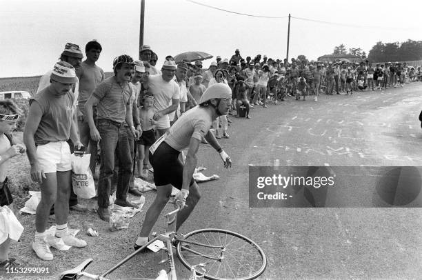 French cyclist Laurent Fignon, wearing the yellow jersey as overall leader, gets ready to change his bike after puncturing a tyre on July 21 during...