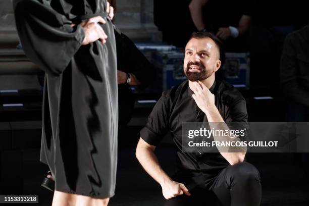 French fashion designer Julien Fournie speaks to a model prior to his Women's Fall-Winter 2019/2020 Haute Couture collection fashion show in Paris,...