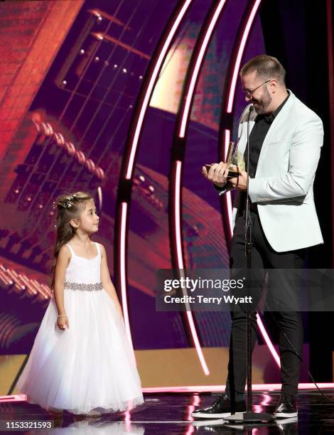 Danny Gokey, winner of Male Artist of the Year, and his daughter accept award onstage during the 7th Annual K-LOVE Fan Awards at The Grand Ole Opry...