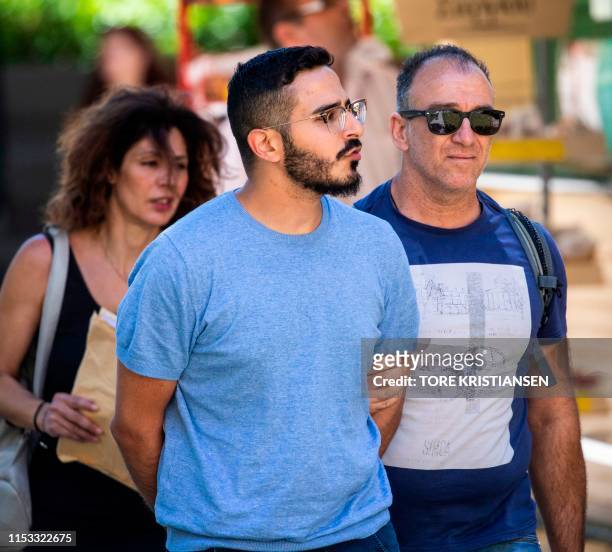 Picture taken on July 1, 2019 shows the so-called "Tinder swindler" as he is expelled from the city of Athens, Greece. - Police in Greece on Tuesday,...