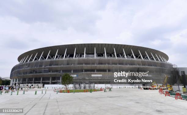 Photo taken July 3 shows Japan's new National Stadium in Tokyo, the main venue for the 2020 Olympics and Paralympics, under construction. ==Kyodo