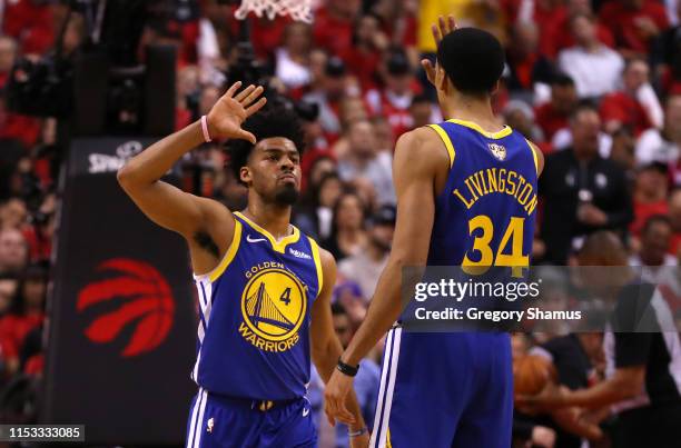Quinn Cook and Shaun Livingston of the Golden State Warriors celebrate the play against the Toronto Raptors in the second half during Game Two of the...