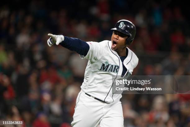 Tim Beckham of the Seattle Mariners points to the dugout after hitting what would be a pinch-hit, game-winning home run in the eighth inning against...