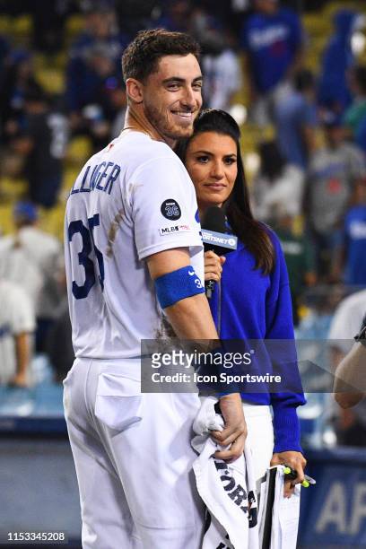 Los Angeles Dodgers right fielder Cody Bellinger looks on with television broadcaster Alanna Rizzo after a MLB game between the Arizona Diamondback...