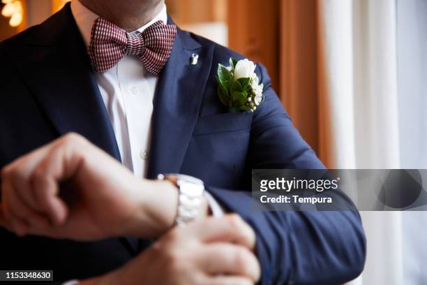 groom taking care of last details before the wedding. putting on cuff links. - cuff link stock pictures, royalty-free photos & images
