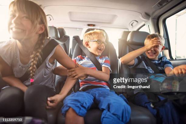 glückliche spielende kinder mit dem auto - happy family in car stock-fotos und bilder