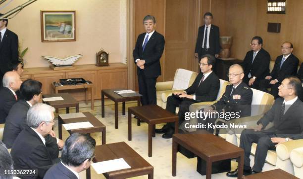 Defense Minister Takeshi Iwaya apologizes to Yamaguchi Gov. Tsugumasa Muraoka at the prefectural government office on July 3 over a mistake in the...