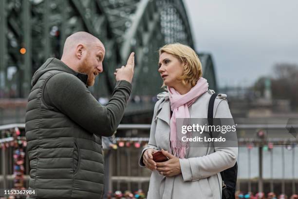 middle aged couple arguing in public - luxury dog house stock pictures, royalty-free photos & images