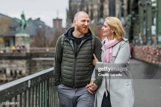 beautiful man and woman tourist couple in germany - cologne winter stock pictures, royalty-free photos & images