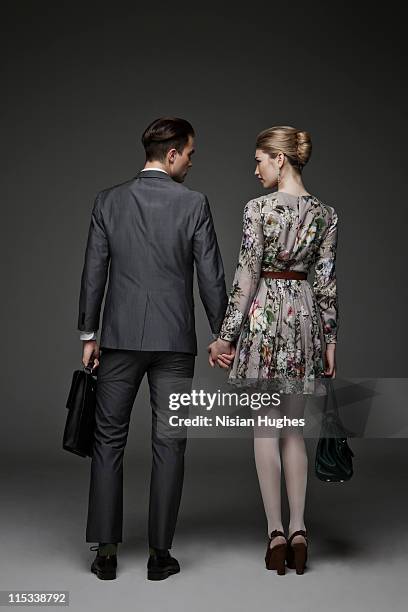 young successful couple holding hands - couple standing full length stock pictures, royalty-free photos & images