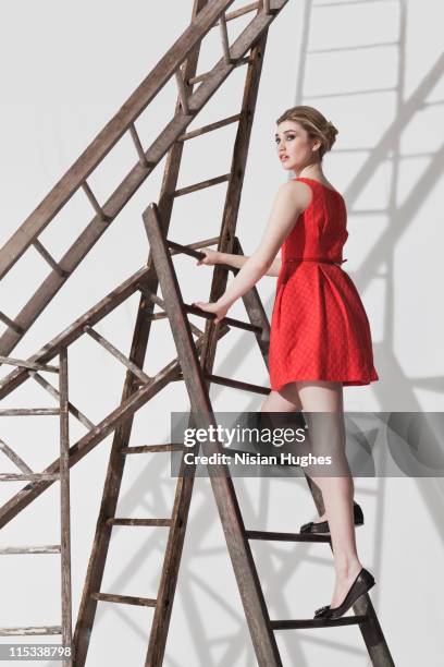 business woman on ladder construction - unstable ladder stock pictures, royalty-free photos & images