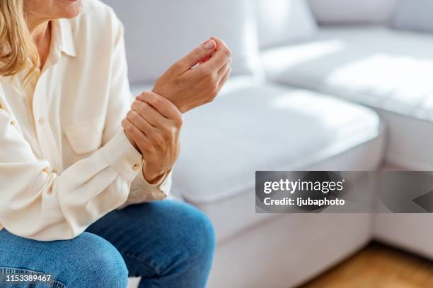 female wrist injury - osteoarthritis stock pictures, royalty-free photos & images