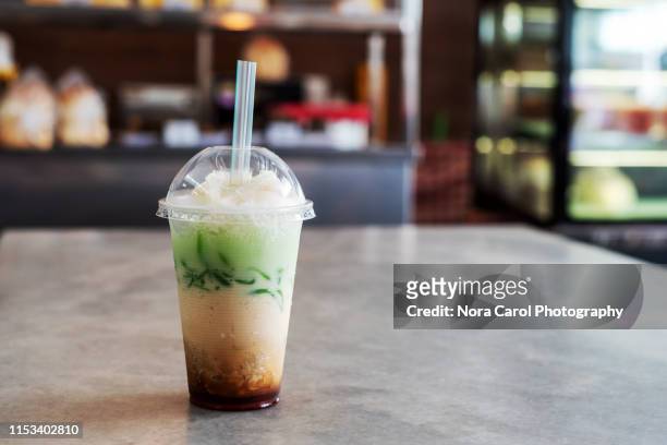 ice cendol in a plastic cup - traditional malay food stock pictures, royalty-free photos & images