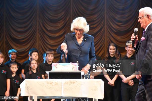 Camilla, Duchess of Cornwall, Patron, The Carmarthen and District Youth Opera , cuts a cake after watching a performance of songs from Chitty Chitty...