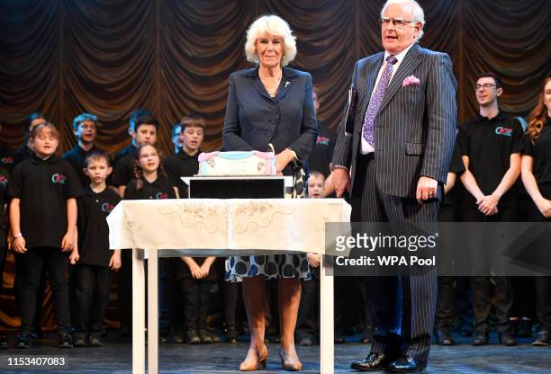 Camilla, Duchess of Cornwall, Patron, The Carmarthen and District Youth Opera ,prepares to cut a cake after watching a performance of songs from...