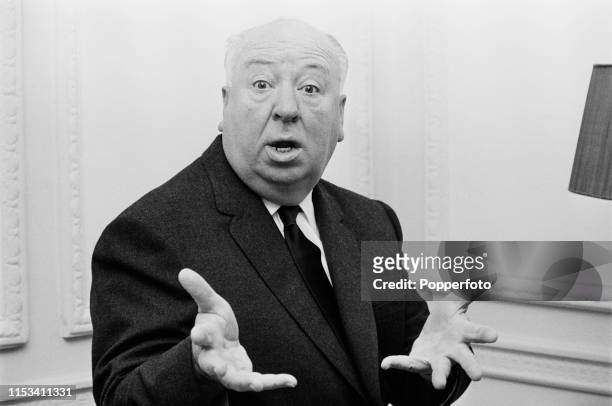 English film director Alfred Hitchcock gestures with his hands towards the camera in November 1964. Alfred Hitchcock is currently visiting England to...