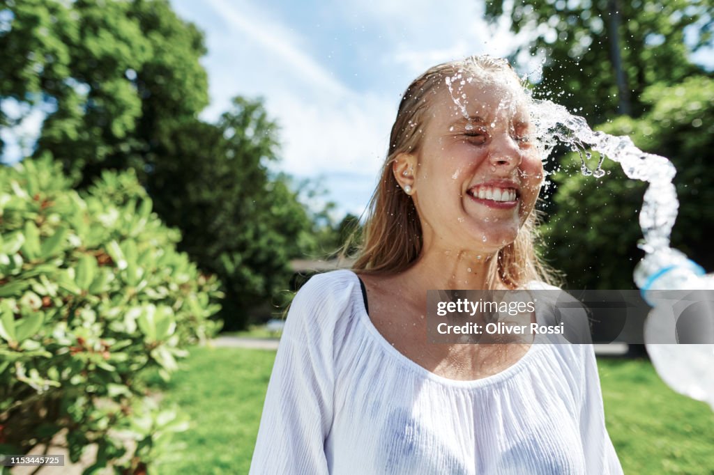 Happy Young Woman Being Splashed With Water In A Park High-Res Stock ...