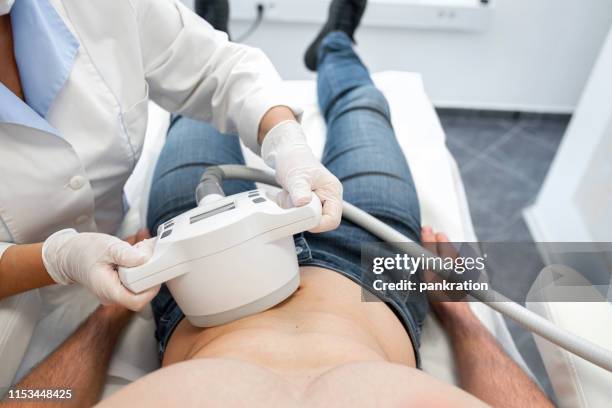 cavitation treatment to reduce abdomen cellulite - liposuction stock pictures, royalty-free photos & images