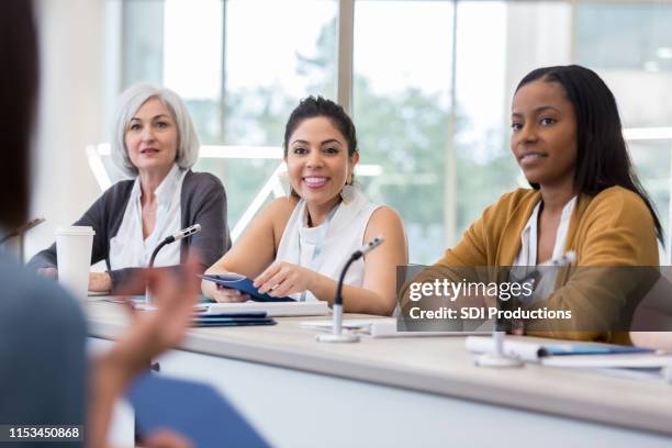 diverse panel of women answer questions during expo - public speaking stock pictures, royalty-free photos & images
