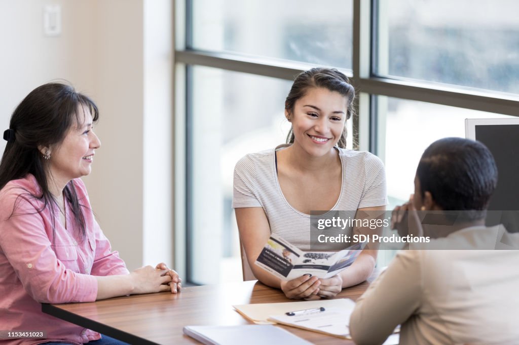 Young woman talks about student loan with loan officer
