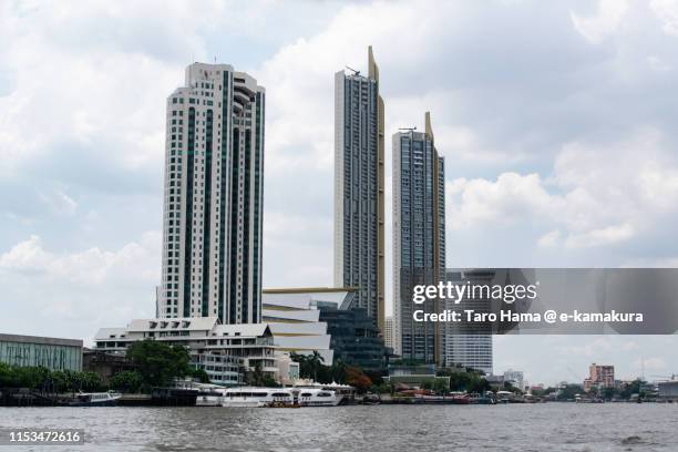 city buildings near chao phraya river in bangkok - river chao phraya stock pictures, royalty-free photos & images