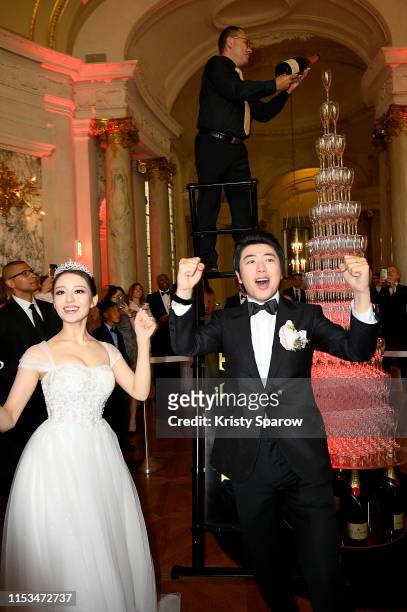 Pianists Lang Lang & Gina Alice celebrate their wedding in front of a Moet et Chandon Champagne pyramid during their Cocktail Wedding at Hotel...