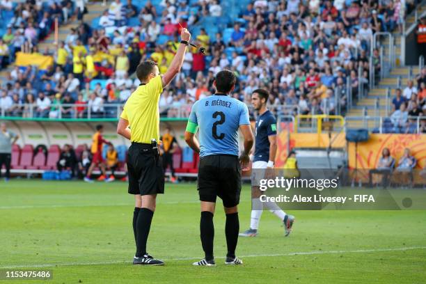 Referee Michael Oliver shows a red card to Bruno Mendez of Uruguay during the 2019 FIFA U-20 World Cup Round of 16 match between Uruguay and Ecuador...