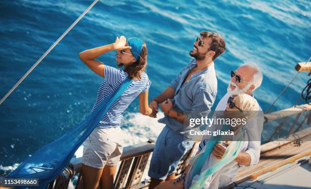 family taking a sailing cruise. - old sailing ship deck stock pictures, royalty-free photos & images