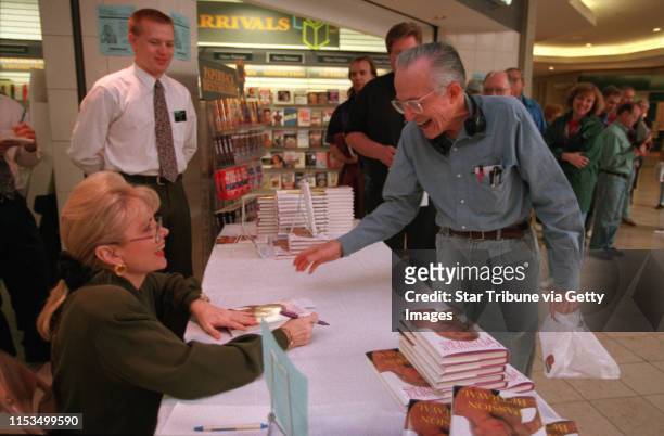 Gennifer Flowers signs her book, "Passion and Betrayal", for Adolph Hill of St. Paul at Waldenbooks.
