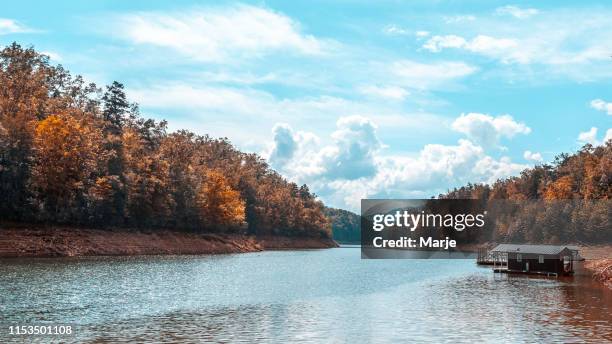 mountain lake with boathouse - autumn in the appalachian mountains - bryson city north carolina stock pictures, royalty-free photos & images