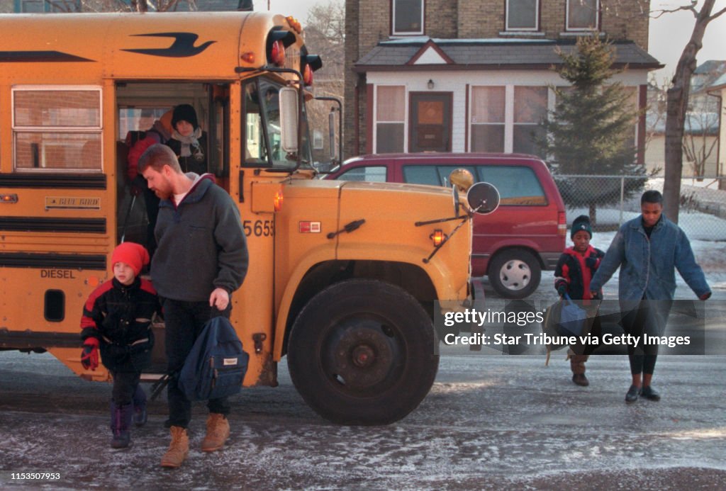 Parents arrived at Holland Elementary School Monday morning with their children. Gary Johnson and his son, Nicholas arrived by bus while Ava Reed and her son Carl Conner, right, came on foot