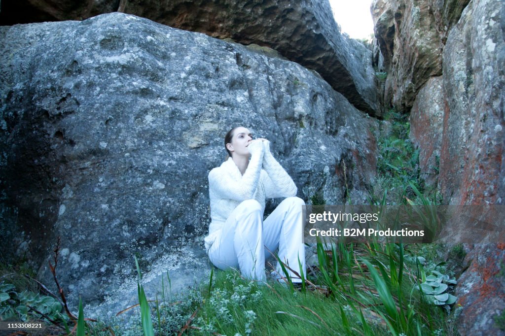 Contemplative Rocking Contemplating Woman Sitting Near Rock High-Res Stock Photo - Getty Images